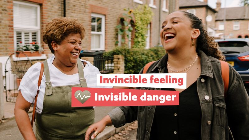 Two ladies laughing in street. Invincible feeling, invisible danger.
