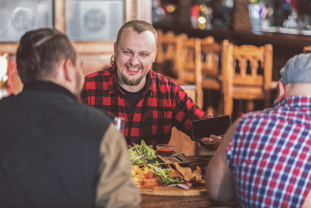 Man eating with friends in pub